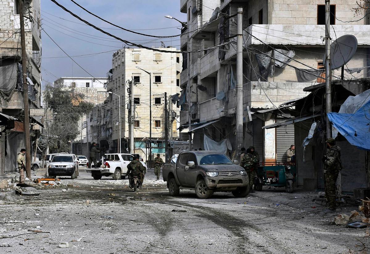 Syrian troops march through the streets of east Aleppo, Syria on Dec. 12, 2016. (SANA via AP)