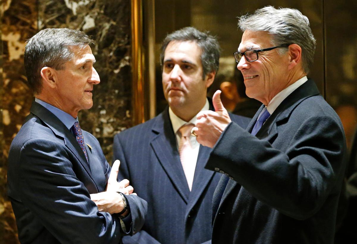 Retired U.S. Army Lieutenant General Michael T. Flynn (L) chats with former Texas Gov. Rick Perry (R) and Trump attorney Michael D. Cohen in the lobby at Trump Tower on Dec. 12, 2016. (AP Photo/Kathy Willens)
