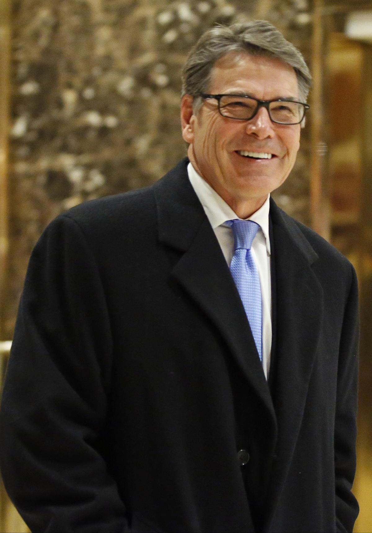 Former Texas Gov. Rick Perry smiles as he leaves Trump Tower in New York on Dec. 12, 2016. (AP Photo/Kathy Willens)