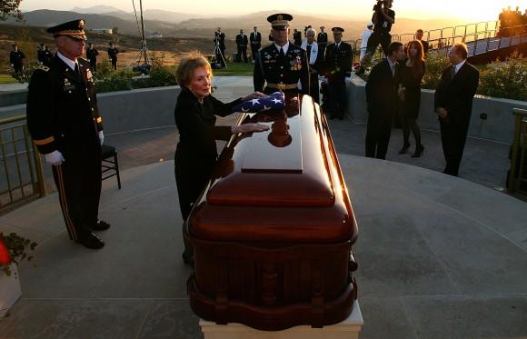 Former first lady Nancy Reagan leans into the casket of former President Ronald Reagan during the interment ceremony at the Ronald Reagan Presidential Library in Simi Valley, Calif. on Jun. 11, 2004. Reagan died of pneumonia due to complications with Alzheimer's at age 93 at his home in California. (Photo by Kevork Djansezian - Pool/Getty Images)