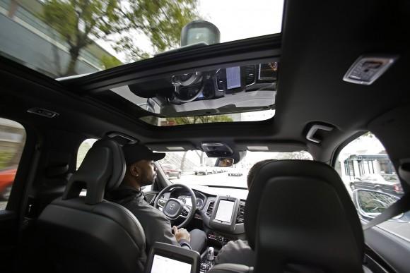 Devin Greene sits in the front seat of an Uber driverless car during a test drive in San Francisco, on Dec 13, 2016. (AP Photo/Eric Risberg)