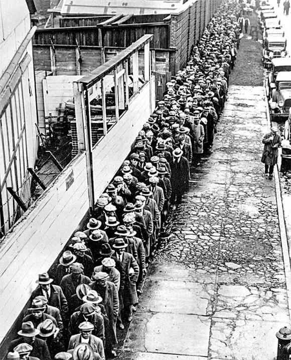 Jobless and homeless men wait to get free dinner at New York's municipal lodging house in the winter of 1932–33. Companies and banks defaulted in droves during the Great Depression because of too much debt, causing a crash in GDP and massive unemployment. (ap photo)