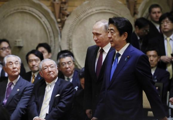 Japanese Prime Minister Shinzo Abe, right, walks with Russian President Vladimir Putin during a joint press conference in Tokyo, Japan, on Dec. 16, 2016. (AP Photo/Alexander Zemlianichenko, Pool)