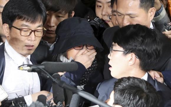 In this file photo, Choi Soon-sil, center, a longtime friend of South Korean President Park Geun-hye, arrives at the Seoul Central District Prosecutors' Office in Seoul, South Korea. (AP Photo/Lee Jin-man, File)