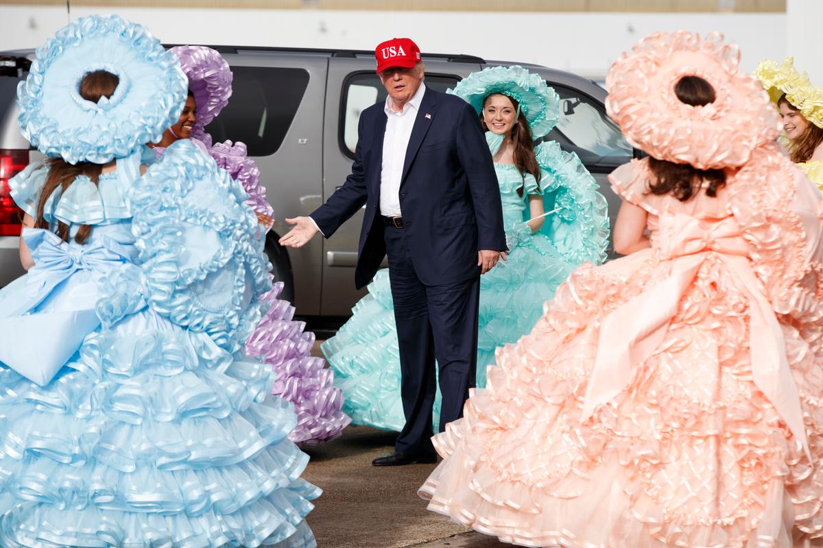 President-elect Donald Trump is greeted by the Azalea Trail Maids after arriving at the airport for a rally at Ladd-Peebles Stadium in Mobile, Al., on Dec. 17, 2016. (AP Photo/Evan Vucci)