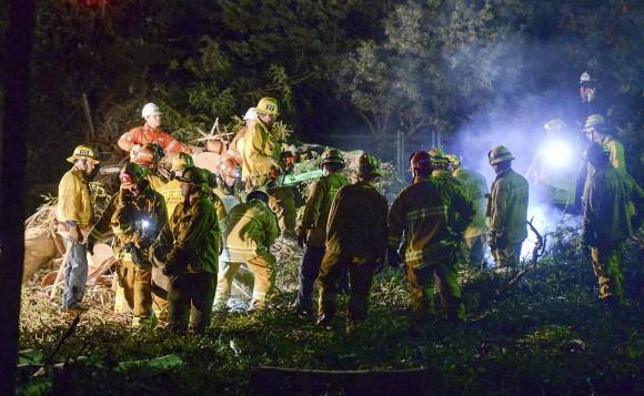 Los Angeles County Fire Dept. firefighters work at the scene where a large tree fell on a wedding party in Whittier, Calif., on, Dec. 17, 2016. (Keith Durflinger/The Whittier Daily News via AP)