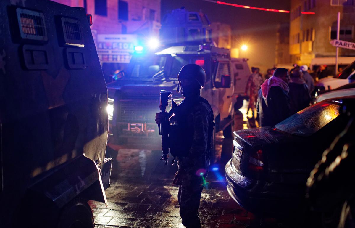 Jordanian security forces stand next to their armored vehicles at the scene next to Karak Castle, during an ongoing attack, in the central town of Karak, about 140 kilometers (87 miles) south of the capital Amman in Jordan on Dec.18, 2016. (AP Photo/Ben Curtis)