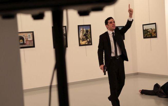A man gestures near to Andrei Karlov on ground, the Russian Ambassador to Turkey at a photo gallery in Ankara, Turkey on Dec. 19, 2016. (AP Photo/Burhan Ozbilici)