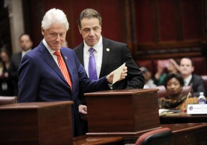 Former President Bill Clinton, left, and New York Gov. Andrew Cuomo, of New York state's Electoral College cast their ballots for Hillary Clinton in the Senate chambers of the Capitol in Albany, N.Y., Monday, Dec. 19, 2016. (AP Photo/Hans Pennink, Pool)