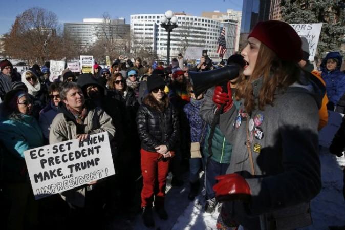 Protestors rally outside the Capitol in Denver, Monday, Dec. 19, 2016, in hopes of persuading the Colorado Electoral College members to join a long-shot national effort to block President-elect Donald Trump. (AP Photo/Brennan Linsley)