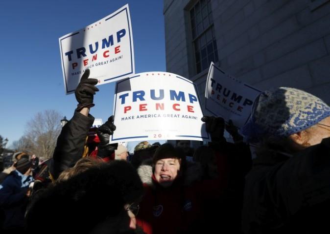 A supporter of President-elect Donald Trump shouts back at anti-Trump protesters outside the state Capitol in Augusta, Maine, Monday, Dec. 19, 2016. Maine's electoral college voters split their vote with 3 ballots for cast for Hillary Clinton and one for Trump. (AP Photo/Robert F. Bukaty)