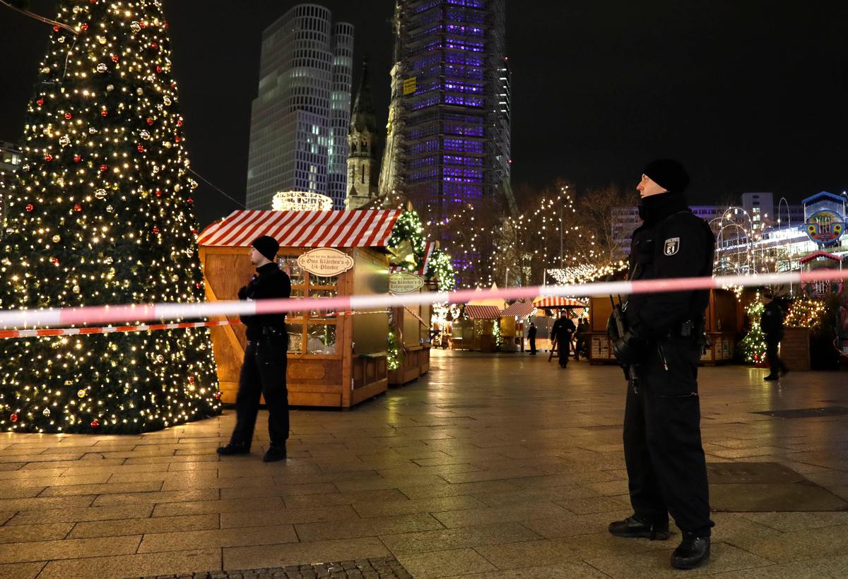 Police guard a Christmas market after a truck ran into the crowded Christmas market in Berliin Berlin, Germany on Dec. 19, 2016. (AP Photo/Michael Sohn)