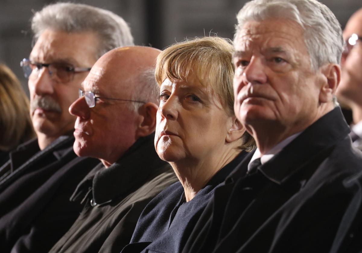 (R-L) German President Joachim Gauck, Chancellor Angela Merkel and the President of the German Parliament, Norbert Lammert, and other politicians attend a memorial service in Berlin's Kaiser-Wilhelm Memorial Church for the victims of a truck attack on a crowded Christmas market the day before, killing several people on Dec. 20, 2016. ( Michael Kappeler/Pool Photo via AP)