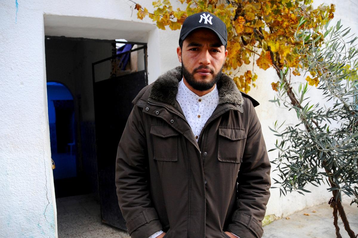 The brother of fugitive Tunisian extremist suspected in Berlin's deadly Christmas market attack, Abdelkader Amri in front of the family house where Anis Amri used to live, in Oueslatia, central Tunisia, on Dec. 22, 2016. (AP Photo/Riadh Dridi)