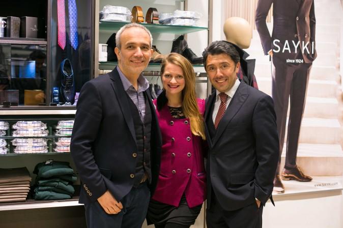 SAYKI owner Hatem Sayki (L) with his staff at the SAYKI grand opening and holiday cocktail event at their first store in New York on Dec. 15, 2016. (Benjamin Chasteen/Epoch Times)