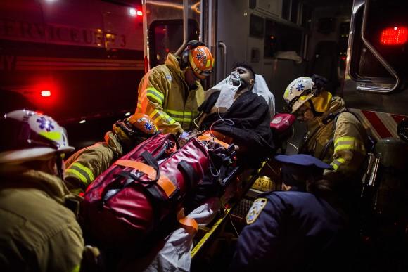 Firefighters load an injured person into an ambulance during a fire on the west side of Manhattan in New York, on Dec. 22, 2016. (AP Photo/Andres Kudacki)