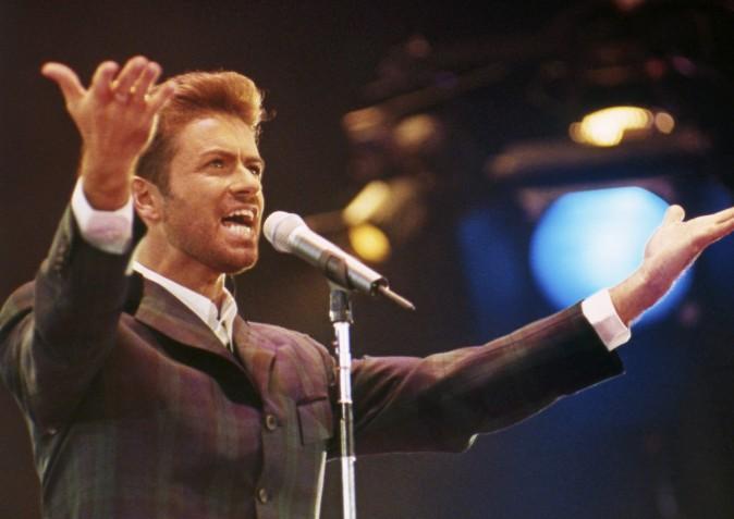 In this Dec. 2, 1993 file photo, George Michael performs at "Concert of Hope" to mark World AIDS Day at London's Wembley Arena. According to a publicist on Dec. 25, 2016, the singer has died at the age of 53. (AP Photo/Gill Allen)