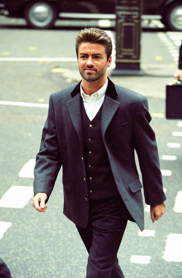 In this Oct. 28, 1993, file photo, pop star George Michael arrives to give evidence at the Royal Courts of Justice in London. Michael was petitioning the court to release him from his contract with Sony Music Entertainment (UK) Ltd. Michael, who rocketed to stardom with WHAM! and went on to enjoy a long and celebrated solo career lined with controversies, has died, his publicist said Sunday, Dec. 25, 2016. He was 53. (AP Photo/Alistair Grant)