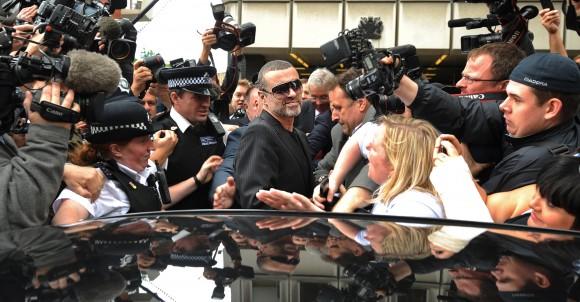 British singer George Michael (C), leaves after appearing at Highbury Corner Magistrates Court in London on Aug. 24, 2010. Michael pleaded guilty to possessing cannabis and driving under the influence of drugs. (BEN STANSALL/AFP/Getty Images)