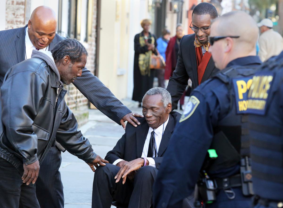 John Pinckney, father of shooting victim Rev. Clementa Pinckney, is greeted after leaving J. Waites Waring Federal Courthouse in Charleston, S.C., on Dec. 15, 2016. (Brad Nettles/The Post And Courier via AP)