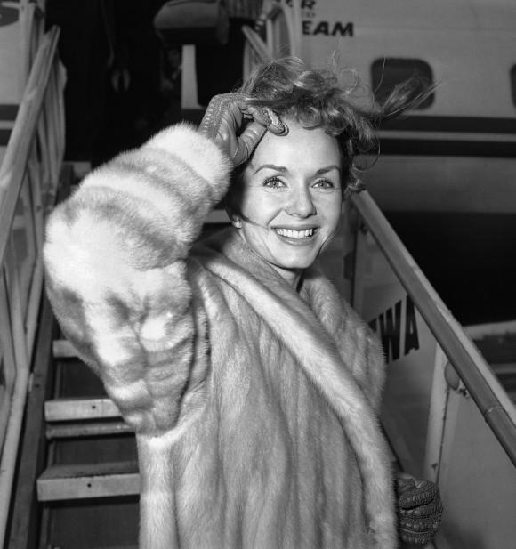 In this file photo, actress Debbie Reynolds boards an airliner in New York en route to Spain where she will film a new picture. (AP Photo/John Rooney)