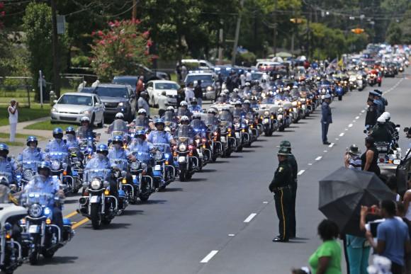 In this file photo, the funeral procession for slain Baton Rouge police Corporal Montrell Jackson leaves the Living Faith Christian Center in Baton Rouge, La. (AP Photo/Gerald Herbert)