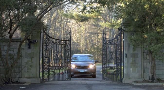 A car with diplomatic license plates drives out of a compound near Glen Cove, N.Y., on Long Island on Friday, Dec. 30, 2016. (AP Photo/Alexander F. Yuan)