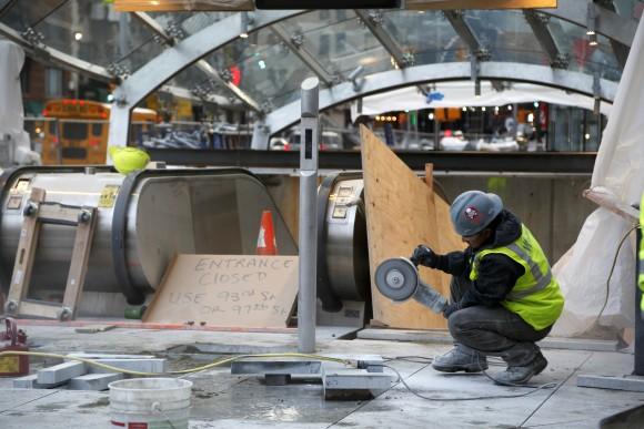 In this file photo, a construction worker cuts stone near an entrance of the unfinished Second Avenue subway in New York. (AP Photo/Seth Wenig)