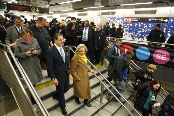 In this file photo, Andrew Cuomo, left, is surrounded by other guests and reporters as he tours the new 86th Street subway station on the Second Avenue subway in New York. (AP Photo/Seth Wenig)