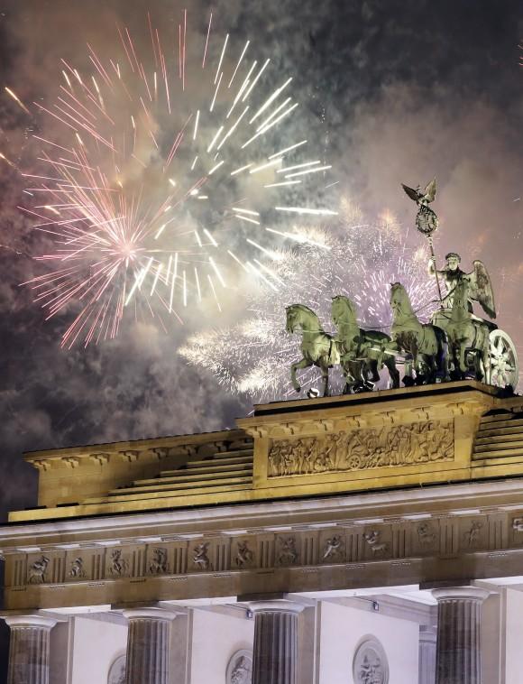 Fireworks light the sky above the Quadriga at the Brandenburg Gate shortly after midnight in Berlin, Germany, on Jan. 1, 2017. (AP Photo/Michael Sohn)