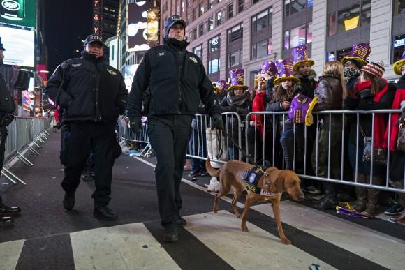 New York police officers walk among revelers who have gathered on Times Square in New York, on Dec. 31, 2016. (AP Photo/Craig Ruttle)