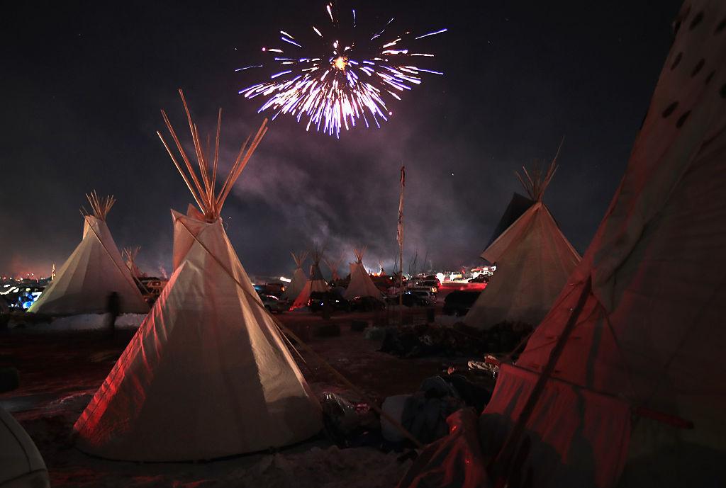 CELEBRATION Fireworks fill the night sky above Oceti Sakowin Camp, near the edge of the Standing Rock Sioux reservation in North Dakota, as activists celebrate after learning an easement had been denied for the Dakota Access Pipeline on Dec. 4. (Scott Olson/Getty Images)