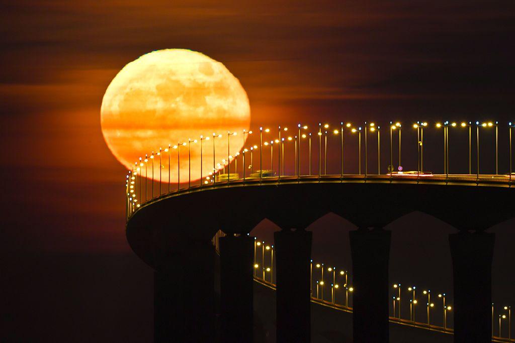 SUPERMOON A full moon rises over the nearly 2-mile-long bridge connecting the French island of Ile de Ré with the mainland near La Rochelle on Dec. 14. (XAVIER LEOTY/AFP/Getty Images)