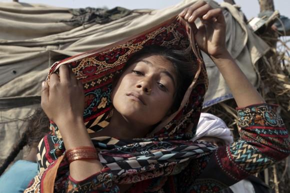 Saima, who married an older man, fixes her scarf during an interview in Jampur, Pakistan, on Dec. 20, 2016. (AP Photo/K.M. Chaudhry)