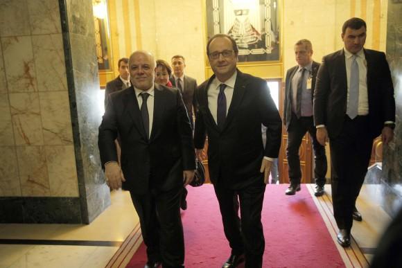 Iraq's Prime Minister Haider al-Abadi, left, greets French President Francois Hollande prior to their meeting in Baghdad, Iraq, Monday, Jan. 2, 2017. Hollande is in Iraq for a one-day visit. (AP Photo/Christophe Ena, Pool)