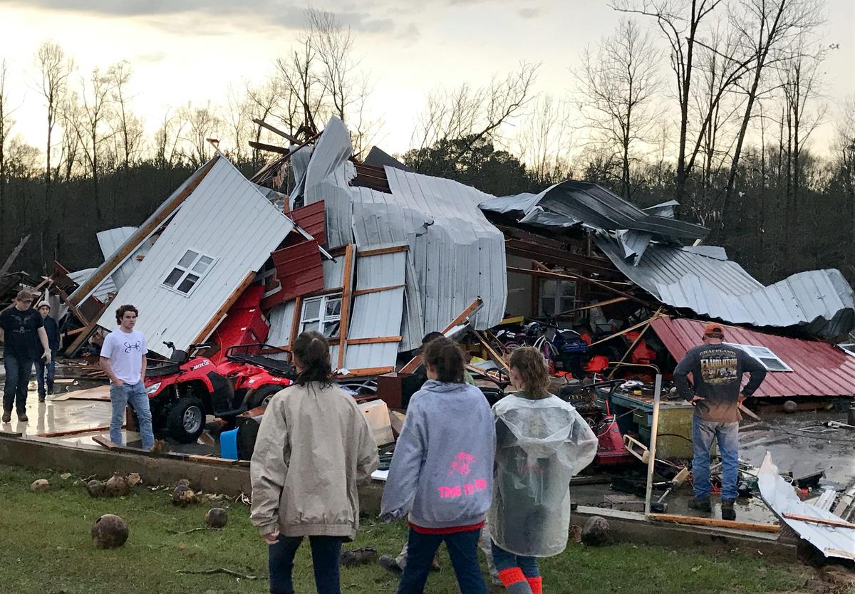 People examine a barn owned by the Miller family that was destroyed during a storm south of Mount Olive, Miss., on Jan. 2, 2017. (Ryan Moore/WDAM-TV via AP)