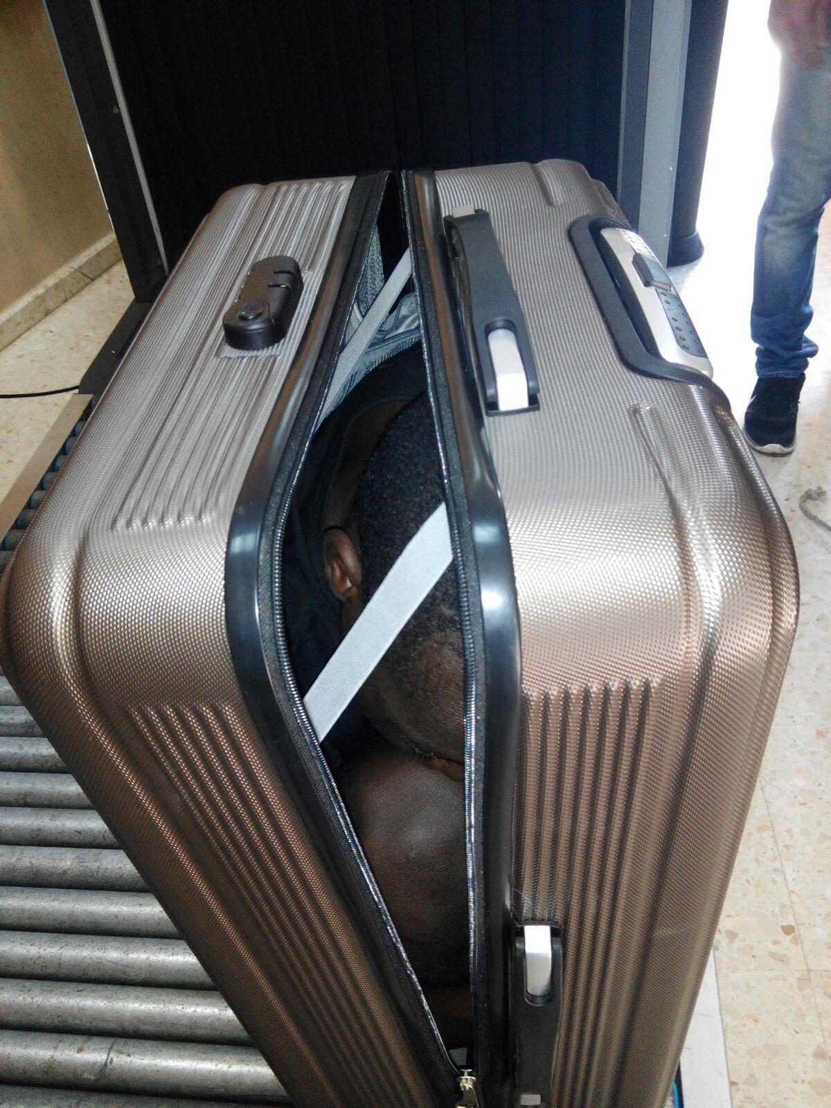 In this photo released by the Spanish Guardia Civil on Tuesday, Jan. 3, 2017, a 19 year-old migrant from Gabon is photographed in a suitcase, in Ceuta, Spain. (AP Photo/Spanish Interior Ministry, via AP)