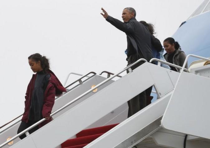 President Barack Obama, first lady Michelle Obama and their daughters Malia, left, and Sasha, right, arrive on Air Force One, Monday, Jan. 2, 2017, in Andrews Air Force Base, Md., en route to Washington as they return from their annual vacation in Hawaii. (AP Photo/Carolyn Kaster)