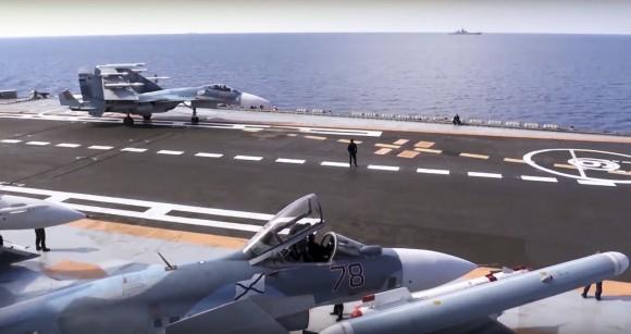 In this file photo, Russian Su-33 fighter jets stand on the flight deck of the Admiral Kuznetsov aircraft carrier in the eastern Mediterranean Sea (Russian Defense Ministry Press Service/ Photo via AP)