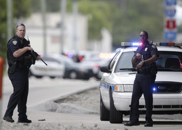 Police officers stand on the perimeter road along the Fort Lauderdale-Hollywood International Airport in Fort Lauderdale, FL., on Jan. 6, 2017. (AP Photo/Lynne Sladky)