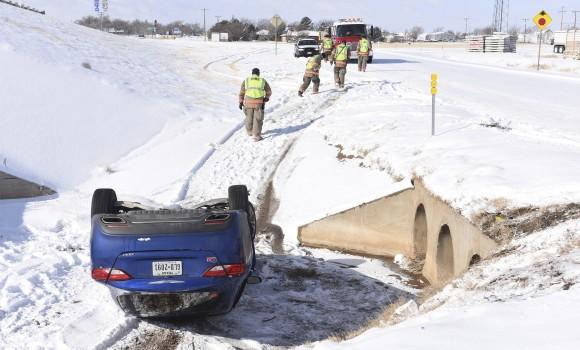 Randall County Emergency responders work an accident at Interstate 27 and Highway 2219, after a driver slide off the service road, in Amarillo, Texas on Jan. 6, 2017. One person was transported to nearby a nearby hospital. (Michael Schumacher/The Amarillo Globe News via AP)