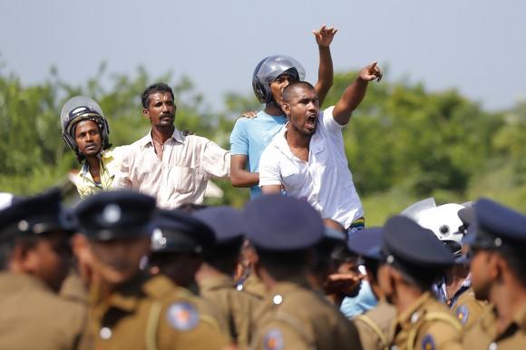 Sri Lankan villagers shout slogans during a protest in Mirijjawila village in Ambalantota, Sri Lanka, Saturday, Jan. 7, 2017. (AP Photo/Eranga Jayawardena)