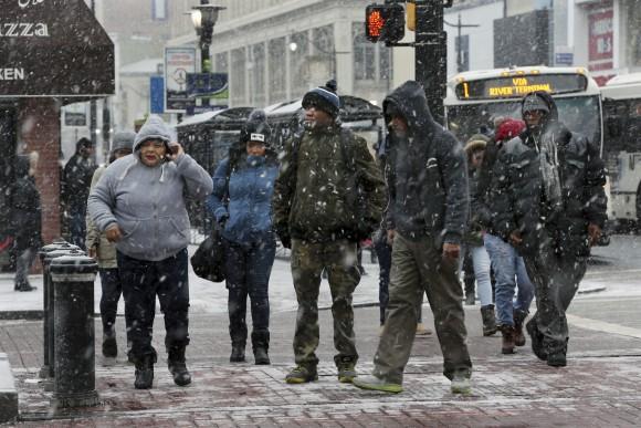 People bundle against the cold and snow as they walk downtown in Newark, N.J. on Jan. 7, 2017. (AP Photo/Mel Evans)