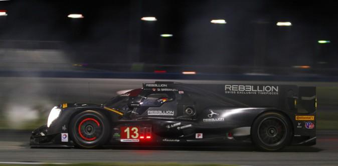 Nick Heidfeld takes a turn behind the wheel of the #13 Rebellion Oreca-Gibson, piercing a cloud of tire smoke during night practice at the 2017 Roar Before the Rolex 24. (Chris Jasurek/Epoch Times)