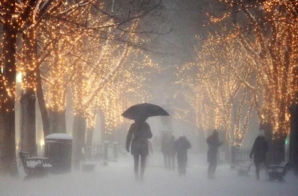 People walk through the Commonwealth Avenue Mall during a winter storm in Boston on Jan. 7, 2017. A storm that wreaked havoc along the East Coast arrived in southern New England on Saturday, bringing blizzard conditions to some areas and making travel treacherous throughout the region. (AP Photo/Michael Dwyer)