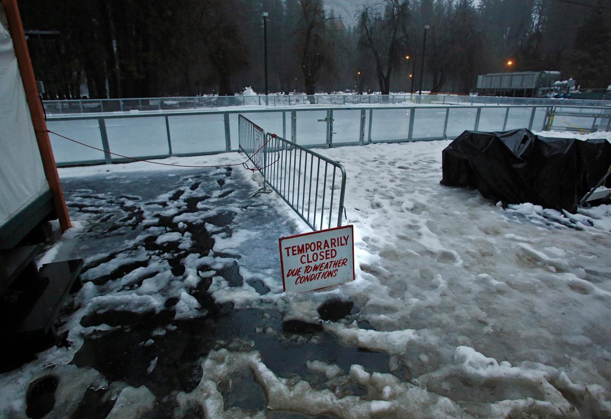 A "closed" sign stands at the entrance of a normally busy ice rink at the Half Dome Village of Yosemite National Park, Calif., on Jan 7, 2016. (AP Photo/Gary Kazanjian)