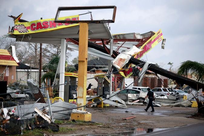 A police officer walks through a damaged gas station along Chef Menture Avenue after a tornado ripped through the eastern part of New Orleans on Feb. 7. According to the weather service, 25 people were injured in the aftermath of the tornado. (Sean Gardner/Getty Images)