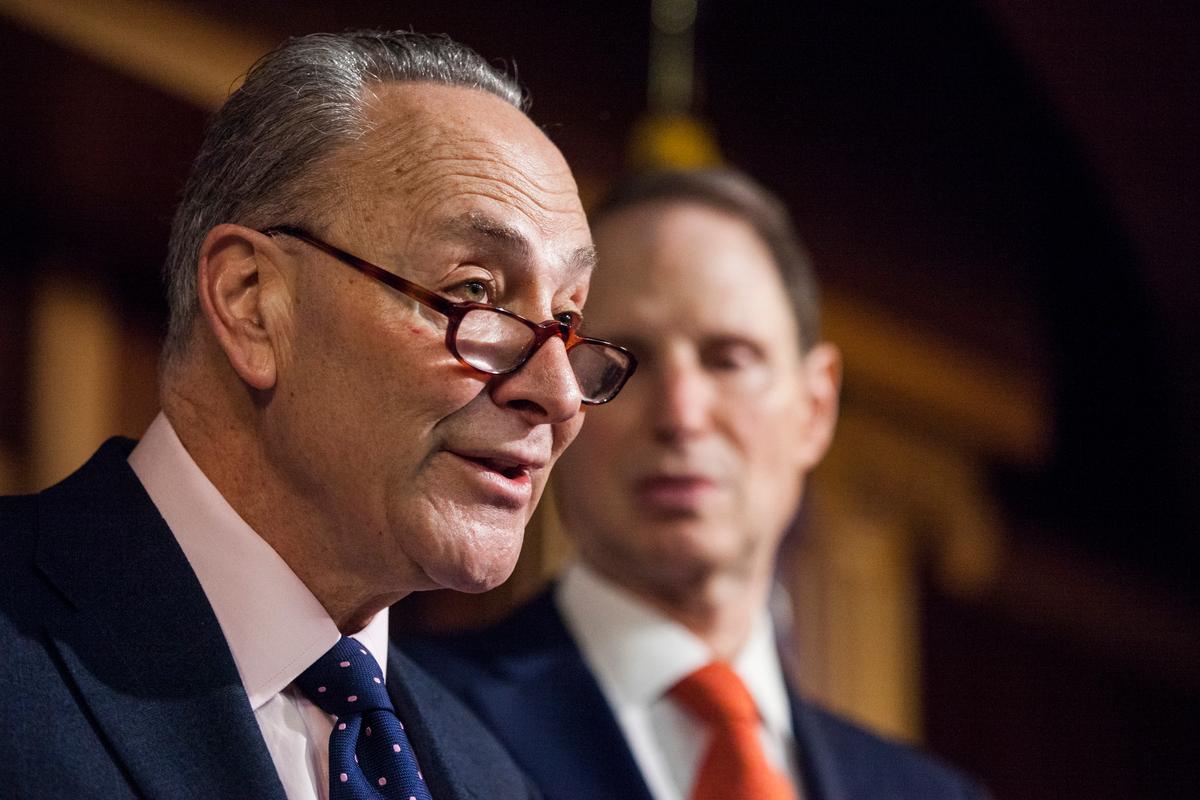 Senate Minority Leader Charles Schumer of N.Y. (L) accompanied by Sen. Ron Wyden, D-Ore., during a news conference on Capitol Hill in Washington on Jan. 5, 2017. (AP Photo/Zach Gibson)