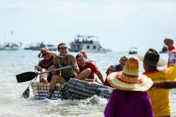 Rosie's boat leads the Beer Can Boat Race during the Darwin Beer Can Regatta at Mindil Beach in Darwin, Australia, on July 9, 2017. The annual event first started in 1974 as a way to clean up beer cans littering local streets. The all-day event includes boat races alongside thong throwing and sandcastle competitions. (Helen Orr/Getty Images)