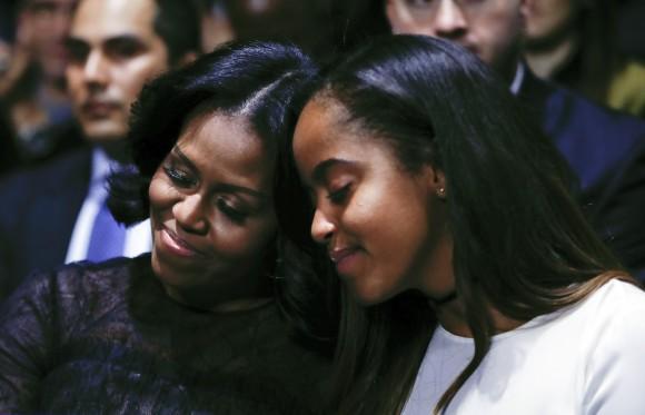 First lady Michelle Obama and daughter Malia lean into one another as they listen to President Barack Obama speak during his farewell address at McCormick Place in Chicago, Tuesday, Jan. 10, 2017. (AP Photo/Pablo Martinez Monsivais)